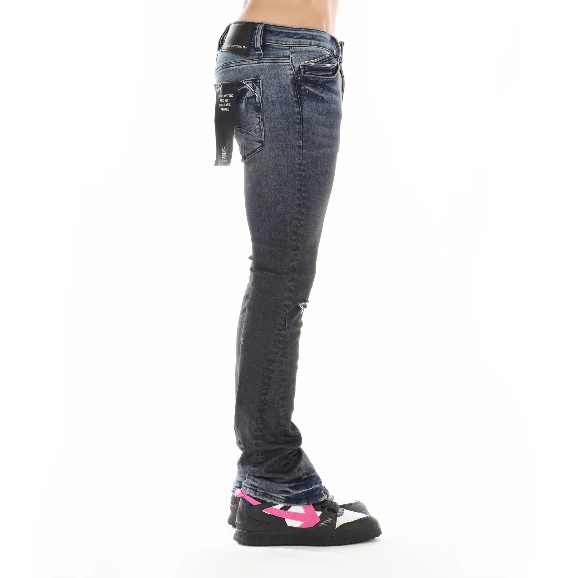 Side view of person wearing Lenny Bootcut in Billie jeans, highlighting the wider leg design and unique accents like the contrasting black inset for added style